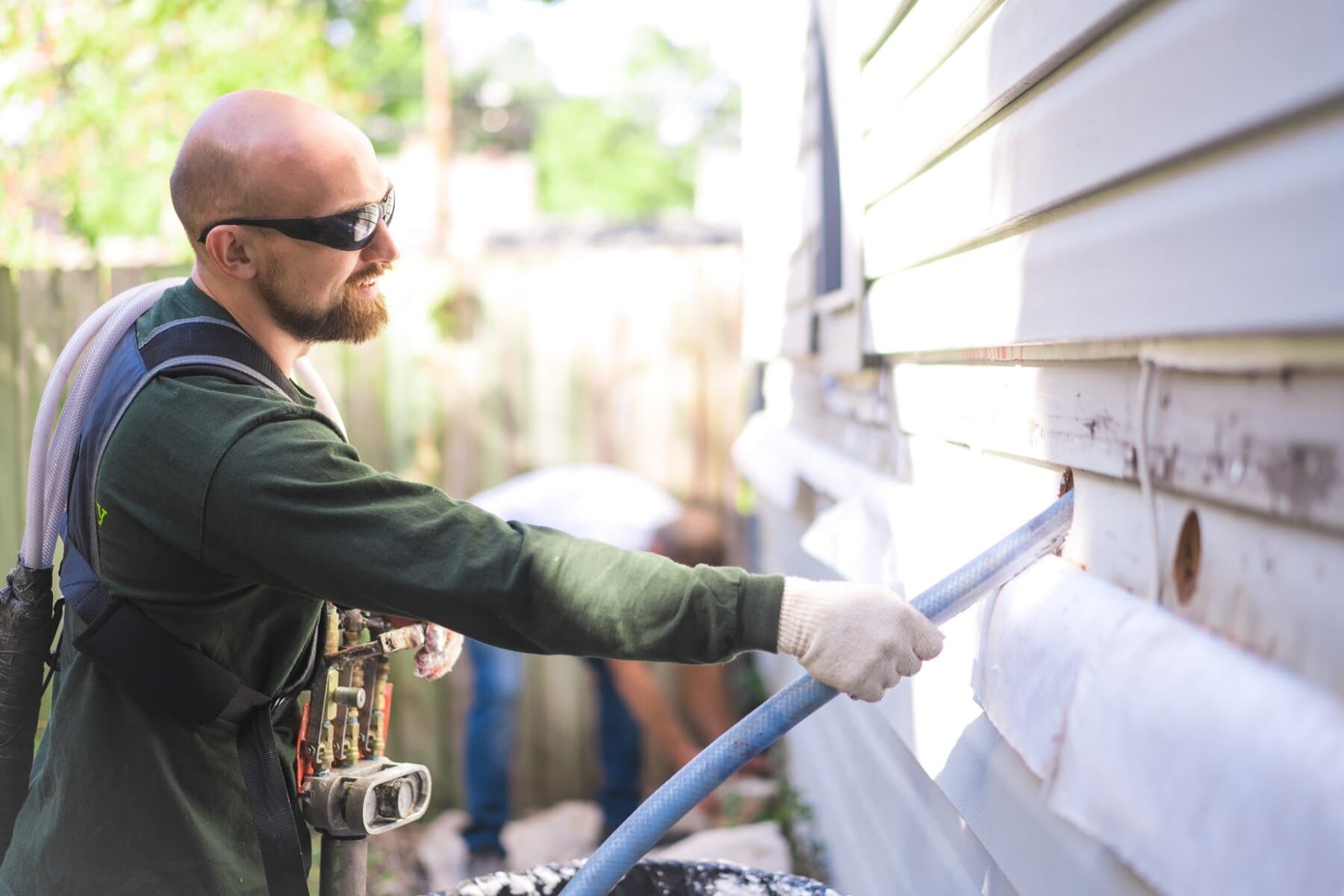 Technician applying spray foam insulation