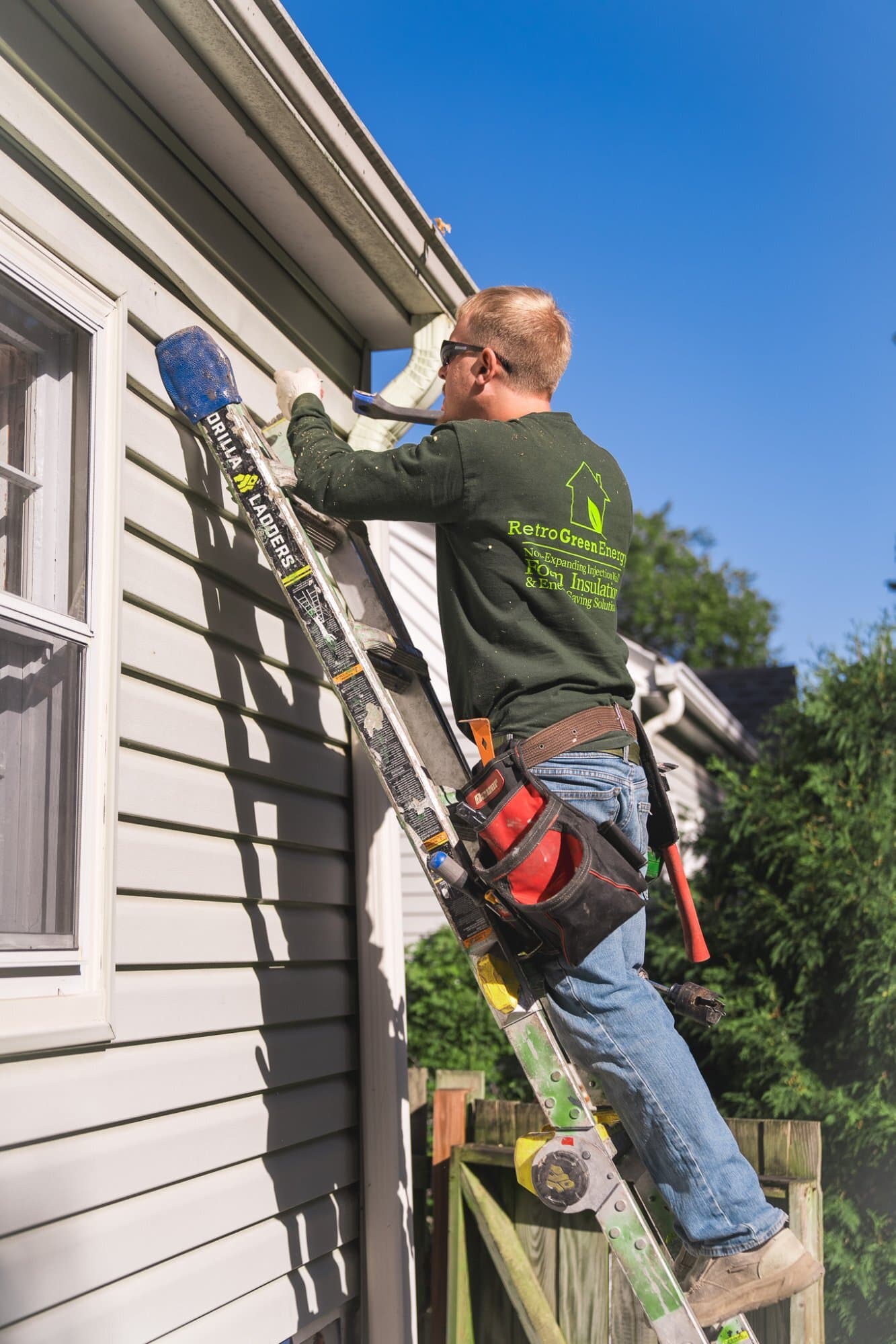 Technician accessing upper areas for insulation work