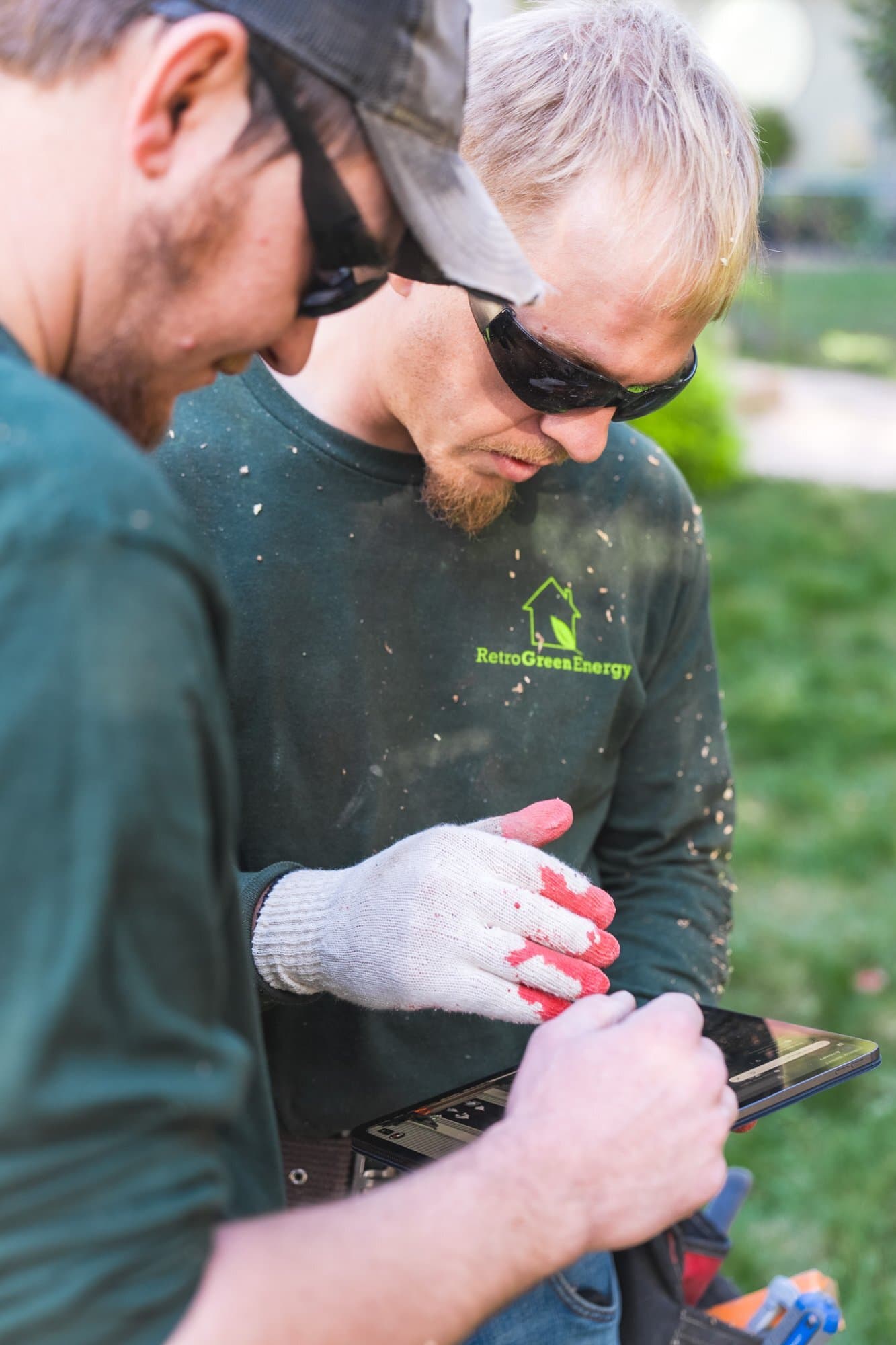 Technicians reviewing a project plan on tablet at job site